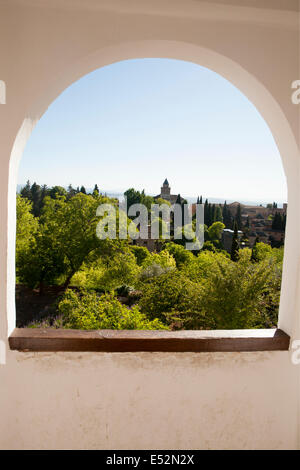 View through stone archway over Generalife palace gardens, Alhambra, Granada, Spain Stock Photo