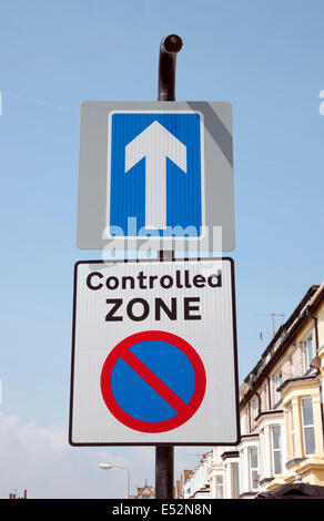 Close up of One way street and controlled traffic zone signs road sign signage England UK United Kingdom GB Great Britain Stock Photo