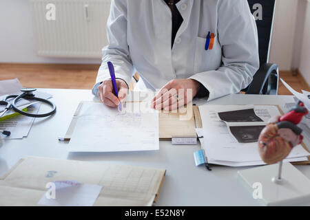 Doctor writes prescription Stock Photo