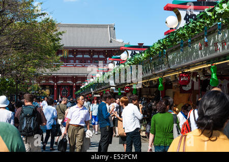 People look and shop around the vendors outside Sensoji Temple in Tokyo, Japan. Stock Photo