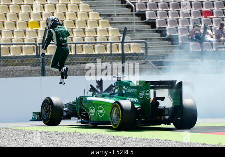 Hockenheim, Germany. 18th July, 2014. Hockenheim, Germany. 18th July, 2014. Japanese Formula One driver Kamui Kobayashi from team Caterham Renault jumps out of his smoking car during the second free practice session at the Hockenheimring race track in Hockenheim, Germany, 18 July 2014. The Formula One Grand Prix of Germany will take place on 20 July 2014 at the Hockenheimring. Photo: BERND WEISSBROD/dpa/Alamy Live News Stock Photo