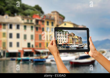 Girl taking pictures on a tablet in Portofino, Cinque Terre, Italy Stock Photo