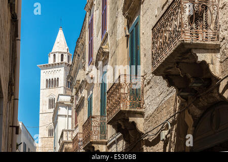 Old iron balconies in Trani's back streets  with the belltower of the cathedral in the background, Trani, Puglia, Italy. Stock Photo
