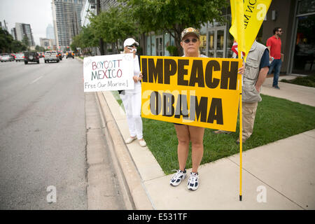 Austin, TX, US. 18th July, 2014. Protesters gathered close to the Mexican Consulate. A group of around 20 individuals were present to voice their opinion which included anti-illegal immigration, anti-Obama and a few advocating for the innocent children. The Texas-Mexico border has seen a surge of immigrants, many children without parents, crossing into the US illegally. Stock Photo