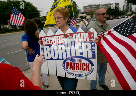 Austin, TX, US. 18th July, 2014. Protesters gathered close to the Mexican Consulate. A group of around 20 individuals were present to voice their opinion which included anti-illegal immigration, anti-Obama and a few advocating for the innocent children. The Texas-Mexico border has seen a surge of immigrants, many children without parents, crossing into the US illegally. Stock Photo