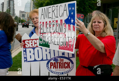 Austin, TX, US. 18th July, 2014. Protesters gathered close to the Mexican Consulate. A group of around 20 individuals were present to voice their opinion which included anti-illegal immigration, anti-Obama and a few advocating for the innocent children. The Texas-Mexico border has seen a surge of immigrants, many children without parents, crossing into the US illegally. Stock Photo