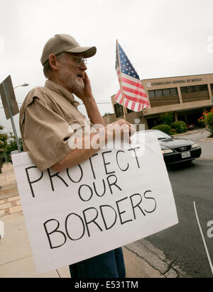 Austin, TX, US. 18th July, 2014. Protesters gathered close to the Mexican Consulate. A group of around 20 individuals were present to voice their opinion which included anti-illegal immigration, anti-Obama and a few advocating for the innocent children. The Texas-Mexico border has seen a surge of immigrants, many children without parents, crossing into the US illegally. Stock Photo