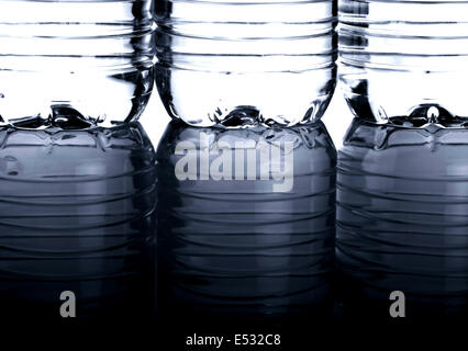 Three PET bottles of water with reflection Stock Photo