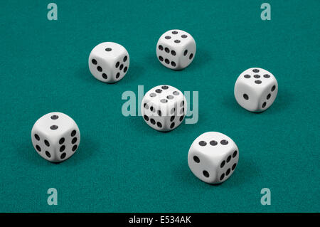 White dice on green felt Stock Photo