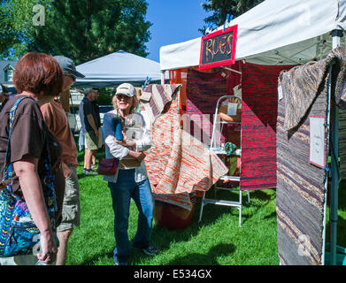 Vendors sell fresh vegetables, produce and other items at a seasonal farmers market in small mountain town of Salida, Colorado Stock Photo