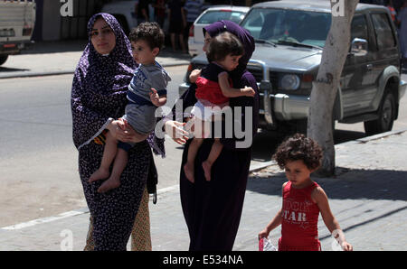 Gaza City, Gaza Strip, Palestinian Territory. 18th July, 2014. Women and children from the family of Al-KHoudary leave their house after an Israeli air raid on it in Gaza City, July 18, 2014. Israel launched a ground campaign Strip after 10 days of bombardment from the air and sea failed to stop the rocket attacks militants, stepping up an offensive that has already taken a heavy toll in civilian lives. Residents and medical officials in Gaza heavy shelling along the eastern border of the southern town of Rafah to the north of the Gaza Strip. Israel pointed out that the invasion be limited in Stock Photo
