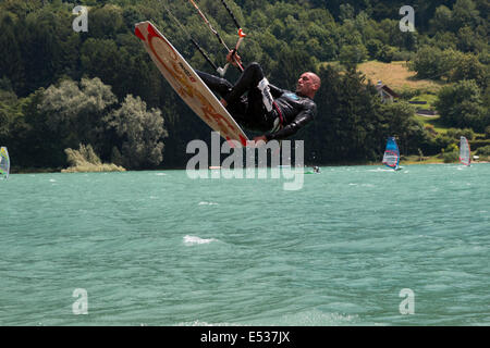 LAKE OF SANTA CROCE, ITALY - JULY 12: Professional kite-surfer demonstrating his ability 2014, July 12, 2014 Stock Photo