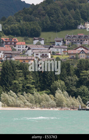 LAKE OF SANTA CROCE, ITALY - JULY 12: Professional kite-surfer demonstrating his ability 2014, July 12, 2014 Stock Photo