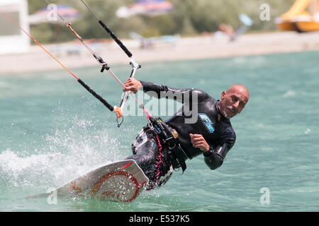 LAKE OF SANTA CROCE, ITALY - JULY 12: Professional kite-surfer demonstrating his ability 2014, July 12, 2014 Stock Photo