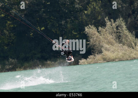 LAKE OF SANTA CROCE, ITALY - JULY 12: Professional kite-surfer demonstrating his ability 2014, July 12, 2014 Stock Photo