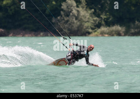 LAKE OF SANTA CROCE, ITALY - JULY 12: Professional kite-surfer demonstrating his ability 2014, July 12, 2014 Stock Photo