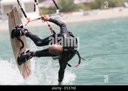 LAKE OF SANTA CROCE, ITALY - JULY 12: Professional kite-surfer demonstrating his ability 2014, July 12, 2014 Stock Photo