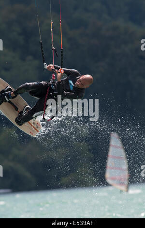 LAKE OF SANTA CROCE, ITALY - JULY 12: Professional kite-surfer demonstrating his ability 2014, July 12, 2014 Stock Photo