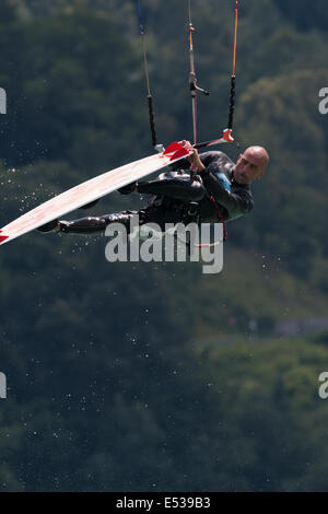 LAKE OF SANTA CROCE, ITALY - JULY 12: Professional kite-surfer demonstrating his ability 2014, July 12, 2014 Stock Photo