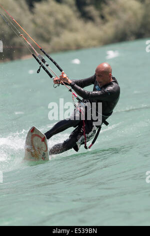 LAKE OF SANTA CROCE, ITALY - JULY 12: Professional kite-surfer demonstrating his ability 2014, July 12, 2014 Stock Photo