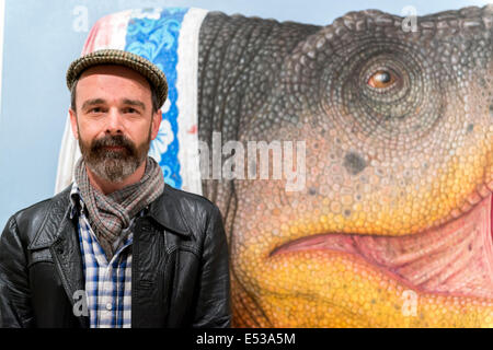 Sydney, Australia. 18th July, 2014. AUSTRALIA, Sydney. 18th July, 2014: 2014 Sulamn Prize winning artist Andrew Sullivan infront of his painting 'T-rex (tryant lizard king) The Archibald, Wynne and Sulman prize are major art prizes run by the Art Gallery of New South Wales with prizes of $75,000, $35,000 and $30,000 respectively. Credit:  MediaServicesAP/Alamy Live News Stock Photo