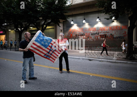 Thessaloniki, Greece. 18th July, 2014. Activists prepare to burn an imitation American flag, with a star of David painted on it in front of United States embassy in Thessaloniki, Greece on July 18, 2014. Credit:  Konstantinos Tsakalidis/Alamy Live News Stock Photo