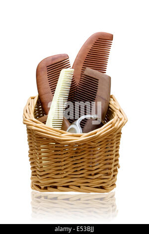 Wooden combs in the Rattan basket isolated on white background Stock Photo
