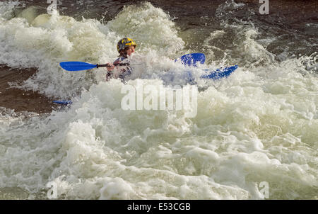 Canoeist getting very wet white water canoeing kayaking at the Cardiff White Water Centre Wales UK Stock Photo