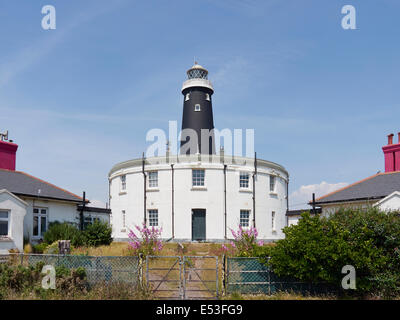 Dungeness old lighthouse with the remains of the earlier one now a house and the keepers houses Stock Photo