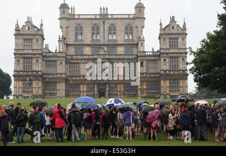 Nottingham, East Midlands, UK.  19th July 2014.  Festival-goers brave humid conditions and heavy rain as they queue outside Wollaton Hall on arrival at the annual Splendour music  festival held in the parkland surrounding the Elizabethan mansion in Nottingham, East Midlands. Credit:  Matthew Taylor/Alamy Live News Stock Photo