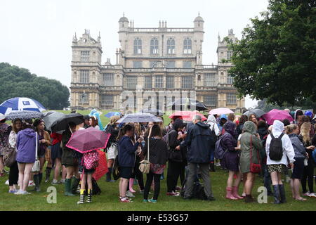 Nottingham, East Midlands, UK.  19th July 2014.  Festival-goers brave humid conditions and heavy rain as they queue outside Wollaton Hall on arrival at the annual Splendour music  festival held in the parkland surrounding the Elizabethan mansion in Nottingham, East Midlands. Credit:  Matthew Taylor/Alamy Live News Stock Photo