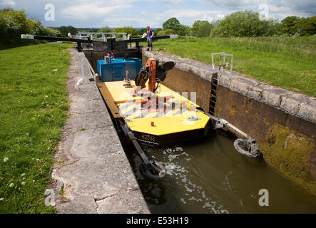 Maintenance boat at Caen Hill flight of locks on the Kennet and Avon canal Devizes, Wiltshire, England Stock Photo