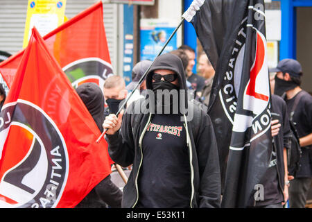 Cricklewood, London, July 19th 2014. Masked anti-fascist activists  counter-protest the anti-Islamist 'South East Alliance' as they demonstrate outside the London offices of Egypt's Muslim Brotherhood. Credit:  Paul Davey/Alamy Live News Stock Photo