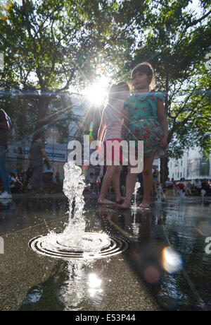 Leicester Square, London, UK. 19th July 2014. Londoners and tourists enjoy the fountains in Leicester Square around the statue of William Shakespeare. Credit:  Matthew Chattle/Alamy Live News Stock Photo
