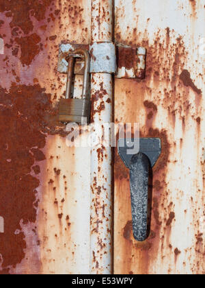 Close up of lock and handle on old rusted metal cellar door, USA, June 15, 2014, © Katharine Andriotis Stock Photo