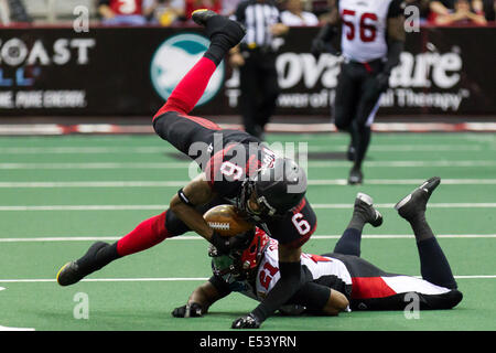 Cleveland, Ohio, USA. 19th July, 2014. Cleveland WR THYRON LEWIS (6) goes down after a hit from Jacksonville DB BRODRICK BROWN (21) during the second quarter. The Cleveland Gladiators defeated the Jacksonville Sharks 62-20 at Quicken Loans Arena in Cleveland, Ohio. Credit:  Frank Jansky/ZUMA Wire/Alamy Live News Stock Photo