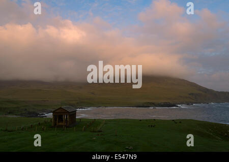 Sunset on the Rum Cuillin hills, across Harris Bay, Isle of Rum, Scotland, UK.  The Bullough Mausoleum in the foreground. Stock Photo