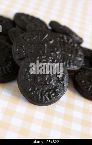 Pontefract Cakes a licorice sweet from Yorkshire stamped with the castle lodge emblem a traditional design dated to 1612 Stock Photo