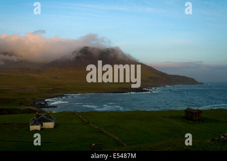 Sunset on the Rum Cuillin hills, Harris Bay, Isle of Rum, Scotland, UK.  Harris Lodge & the Bullough Mausoleum in foreground. Stock Photo