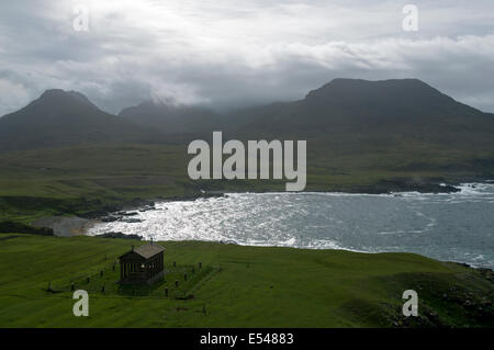 The Bullough Mausoleum and the peaks of Trollaval and Ruinsival in the Rum Cuillin hills, Harris Bay, Isle of Rum, Scotland, UK. Stock Photo