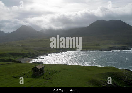 The Bullough Mausoleum and the peaks of the Rum Cuillin hills, Harris Bay, Isle of Rum, Scotland, UK. Stock Photo