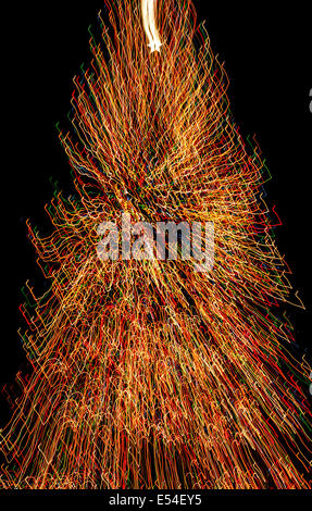 More than 20,000 multicolored lights on a huge Christmas tree create fascinating streaks for this time-exposure photo in New York City, New York, USA. Stock Photo