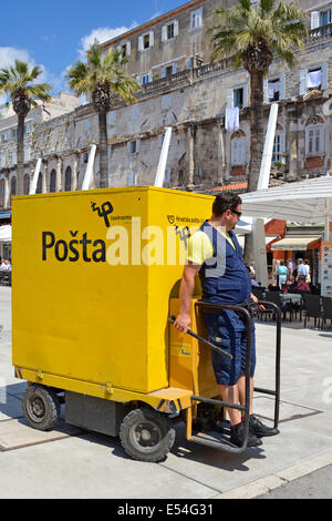 Postman driving an unusual Posta delivery vehicle in Split town centre postal service Stock Photo