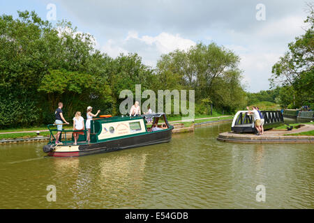 Canal Barge Navigating Through The Swingbridge At Foxton Locks Market Harborough Leicestershire UK Stock Photo