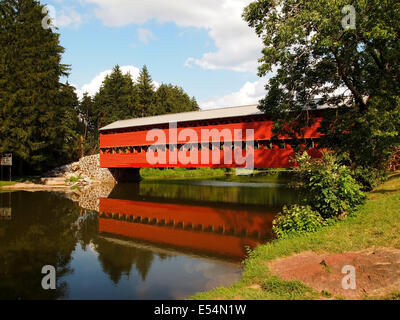 The Sauck's Bridge, near Gettysburg, Pennsylvania, reflects in the water on Marsh Creek on a summer day. Stock Photo