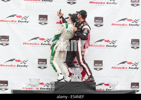 Toronto, Canada. 20th July, 2014. Ed Carpenter Racing's British driver Mike Conway (L) takes a selfie with Tony Kanaan (C) of Target Chip Ganassi Racing and Will Power of Team Penskecelebrates during the award ceremony of the race two of the 2014 Honda Indy Toronto of IndyCar Series race in Toronto, Canada, July 20, 2014. Ed Carpenter Racing's British driver Mike Conway won the race two title of the 2014 Honda Indy Toronto on Sunday. Credit:  Zou Zheng/Xinhua/Alamy Live News Stock Photo