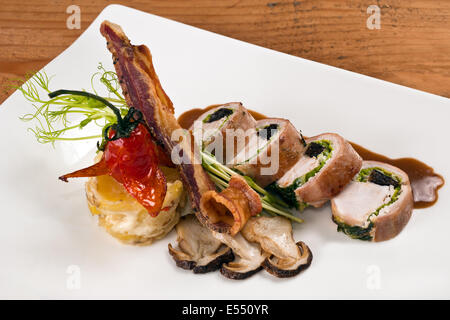 Loin of rabbit with bacon and mushrooms Stock Photo