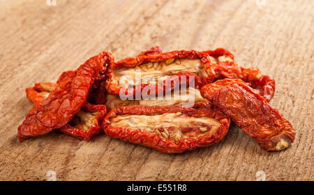 Dried tomatoes  on wood background. Stock Photo