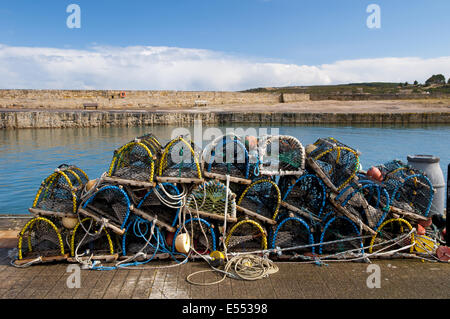Pile of lobster pots stacked on quayside, Hopeman Harbour, Morayshire, Scotland, March Stock Photo