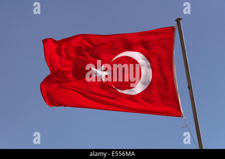 Turkish Flag with crescent and star against blue sky Stock Photo